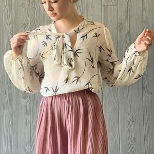 Shear white blouse with delicate branch leaves.